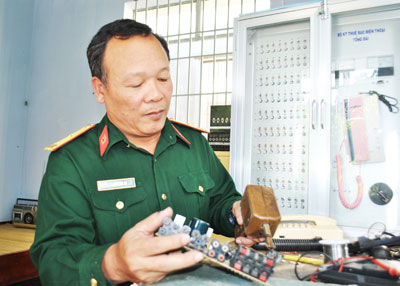Thiếu tá Lâm Văn Tự với công việc sửa chữa khí tài. 