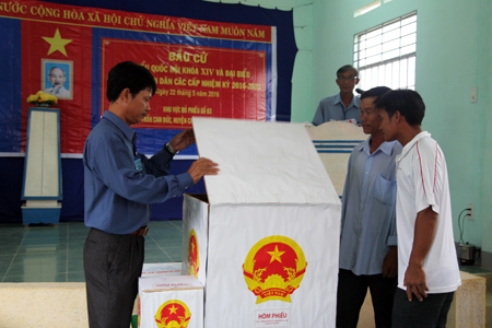 2 cử tri chứng kiến việc kiểm tra hòm phiếu trước giờ bỏ phiếu ở khu vực bỏ phiếu số 3, thị trấn Cam Đức, huyện Cam Lâm
