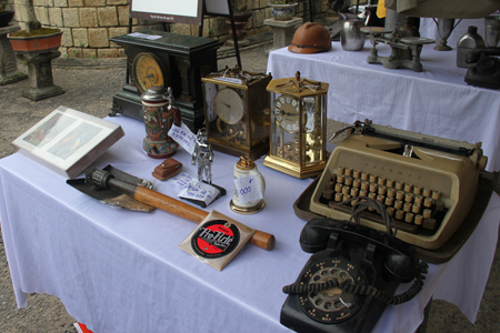 Ancient typewriters, telephone, clocks, etc. displayed at antique fair.