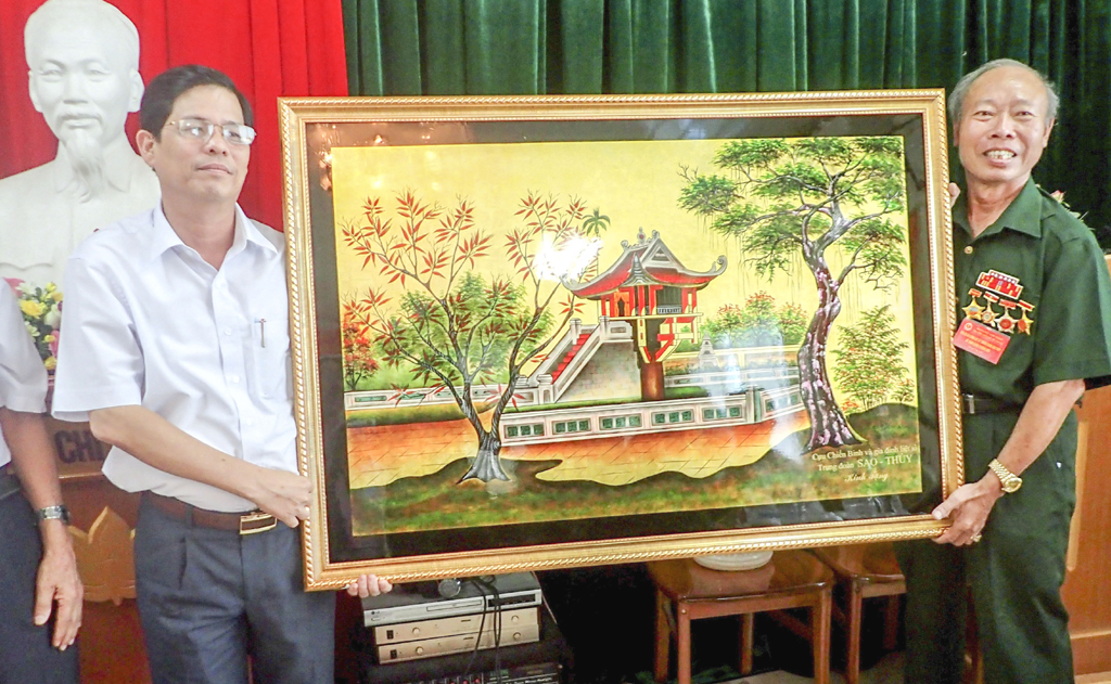Ông Nguyễn Tấn Tuân tiếp nhận bức tranh do Đoàn cựu chiến binh Sao Thủy tặng.