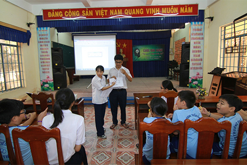 Nhóm của Vân đang thuyết trình kiến thức về rác thải và bảo vệ môi trường cho học sinh Trường Tiểu học Phước Tiến