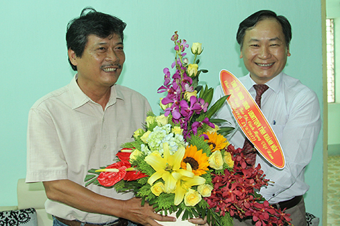 Ông Nguyễn Đắc Tài tặng hoa chúc mừng lãnh đạo Văn phòng đại diện Báo Thanh Niên.