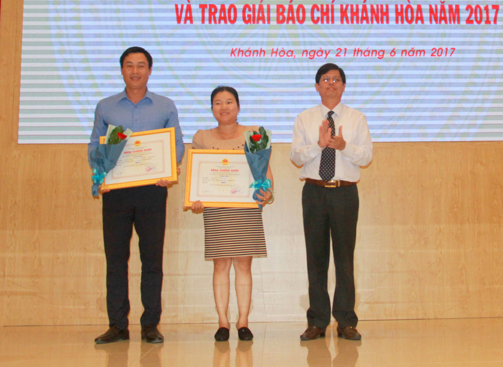 Đồng chí Nguyễn Tấn Tuân trao giải Nhất cho đại diện 2 nhóm tác giả.