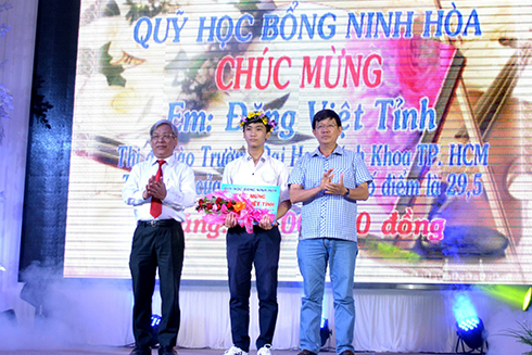 Ông Lê Xuân Thân (bìa trái) cùng lãnh đạo thị xã Ninh Hòa trao phần thưởng cho em Đặng Việt Tỉnh. 