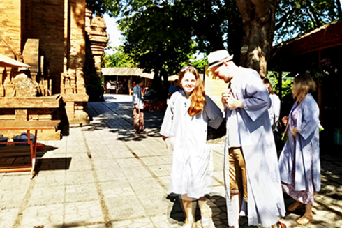 Foreign tourist wearing long robes before entering temples at Ponagar Temple.