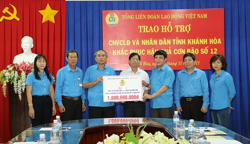  Ông Bùi Văn Cường (thứ 3 từ phải qua) trao biểu trưng 1 tỷ đồng cho công nhân, viên chức, lao động và nhân dân Khánh Hòa khắc phục hậu quả bão lụt.