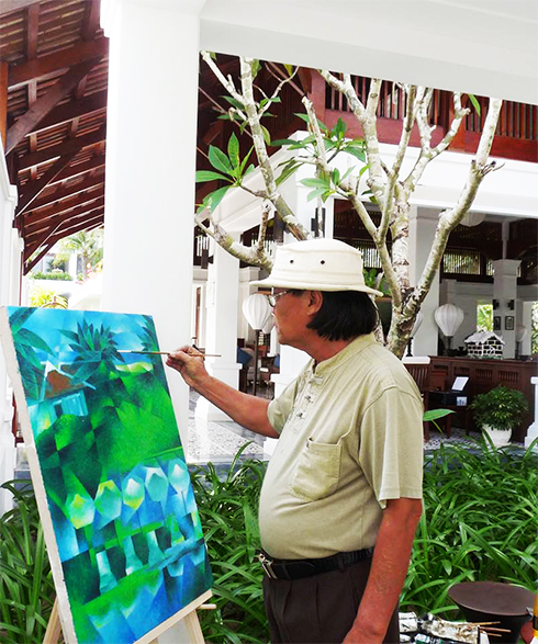 Painter Ngo Thai Binh is painting at The Anam Resort.