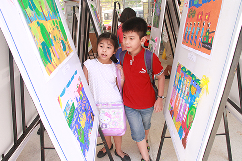 Các em nhỏ xem tranh tại triển lãm tranh Giải thưởng mỹ thuật thiếu nhi năm 2017.
