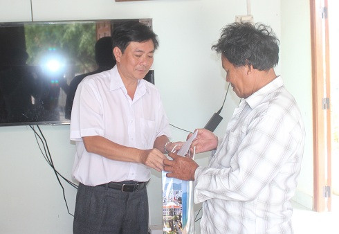 Ông Lữ Thanh Hải (bên trái) thăm hỏi, tặng quà cho đại diện gia đình bà Đăng Thị Năm.