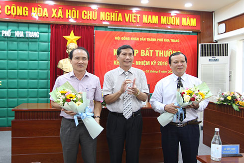 Ông Nguyễn Lê Đình Trị - Chủ tịch HĐND TP. Nha Trang tặng hoa chúc mừng ông Bảo Thọ (phải) và ông Nguyễn Tuấn Thanh.