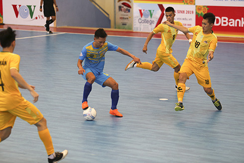 Cầu thủ Khắc Chí (áo xanh) xoay sở tài tình trong vòng vay của các cầu thủ Cao Bằng.