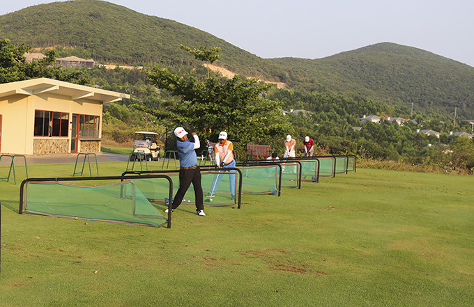 Các golfer tại bãi tập chuẩn bị trước giờ thi đấu.