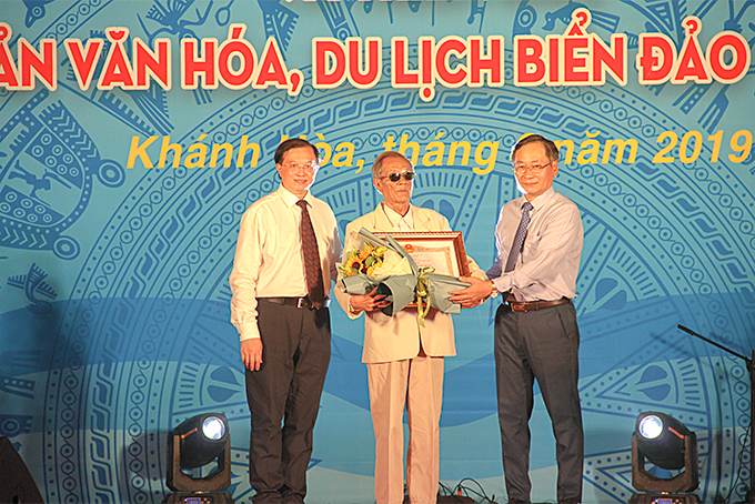 Lãnh đạo Bộ Văn hóa, Thể thao và Du lịch cùng lãnh đạo tỉnh Khánh Hòa trao bằng chứng nhận Nghệ nhân Nhân dân cho nghệ nhân Trần Rí.