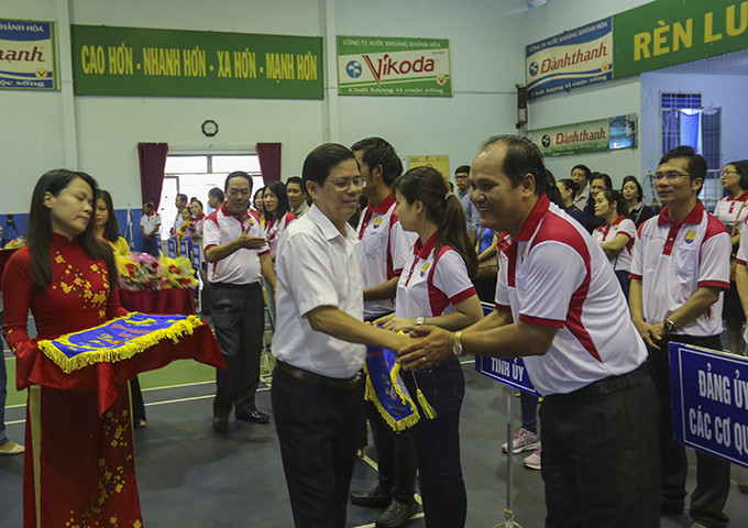 Đồng chí Nguyễn Tấn Tuân-Phó Bí thư Thường trực Tỉnh ủy, Chủ tịch HĐND tỉnh tặng cờ lưu niệm cho các đoàn vận động viên dự hội thao.