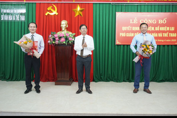 Ông Nguyễn Tấn Tuân trao quyết định và tặng hoa chúc mừng ông Nguyễn Tuấn Thanh (bìa trái) và ông Lê Văn Hoa (bìa phải). 