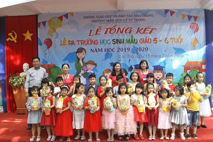 Ban giám hiệu nhà trường và Ban đại diện hội cha mẹ học sinh tặng quà cho học sinh đạt danh hiệu bé ngoan xuất sắc.