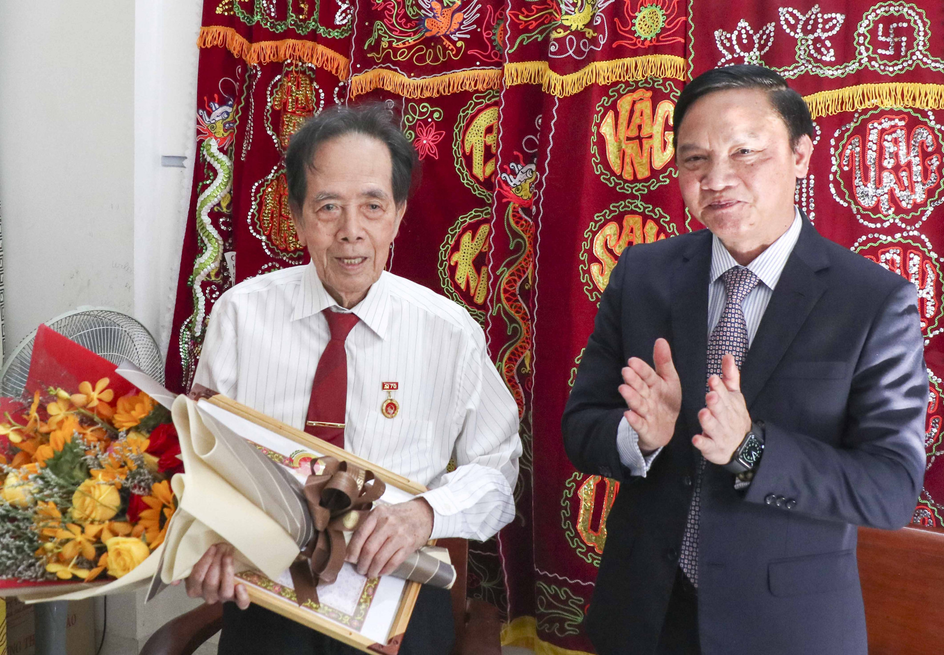 Ông Nguyễn Khắc Định trao Huy hiệu 70 năm tuổi Đảng cho đảng viên lão thành Phan Hữu Sâm.