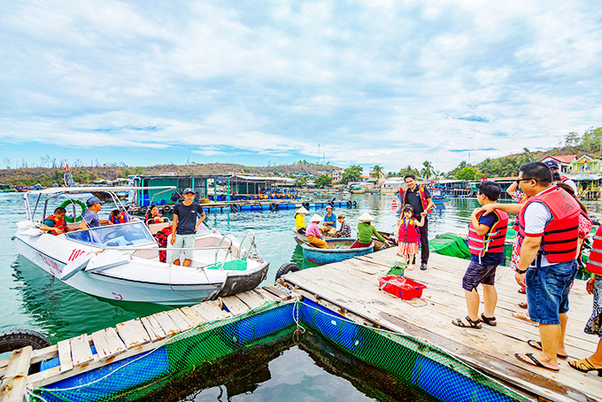 Khách du lịch tham quan các bè nuôi thủy sản trên vịnh Nha Trang. 