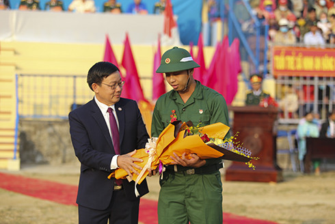 Ông Nguyễn Vĩnh Thạnh, Chủ tịch UBND thị xã Ninh Hòa tặng hoa cho thanh niên trước lúc lên đường nhập ngũ.