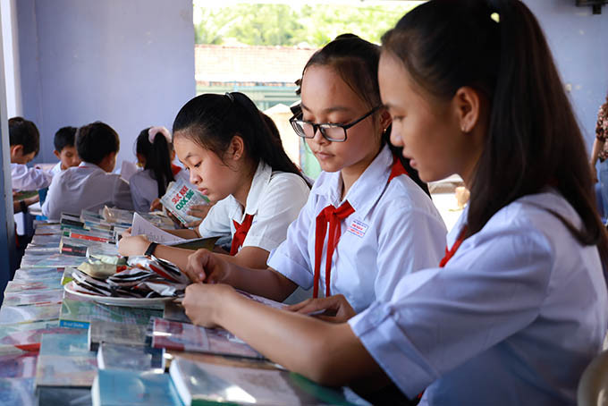 Học sinh Trường THCS Chu Văn An (phường Ninh Đa, thị xã Ninh Hòa) đọc sách được trưng bày tại tổ dân phố Hà Thanh 1. 