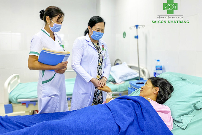 Bác sĩ Hương kiểm tra sức khỏe bệnh nhân sau mổ.