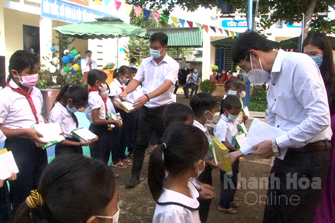 Ông Đinh Văn Thiệu trao quà cho các em học sinh tại xã Ba Cụm Bắc, huyện Khánh Sơn