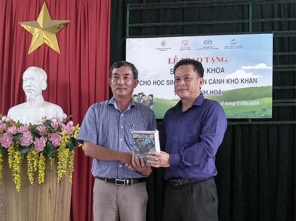 Đại diện Phòng Giáo dục và Đào tạo huyện Diên Khánh (bên trái) tiếp nhận vở do công ty trao tặng. 