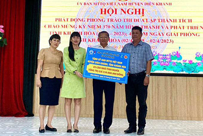 Đại diện Công ty Cổ phần Nước giải khát Yến sào Khánh Hòa trao bảng tượng trưng ủng hộ xây nhà cho người nghèo.