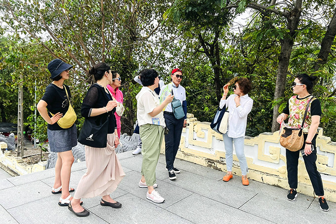 Một người Hàn Quốc dẫn khách tham quan tại chùa Long Sơn.